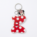 Porte-clés Minnie rouge à pois blancs et médaillon sur fond blanc mat