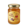 Pot de miel de fleurs Winnie l’Ourson Disneyland Paris 125 g, étiquette jaune et couvercle doré, sur fond blanc.