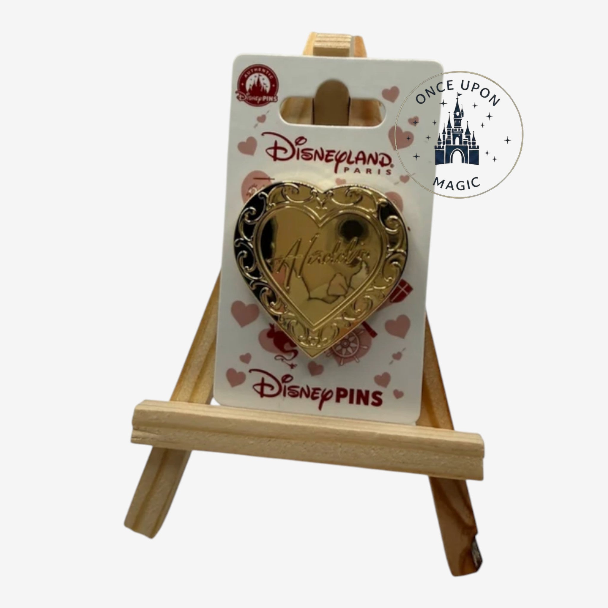 Once Upon Magic gold heart-shaped Aladdin pin with ornate detailing and a hinged opening revealing Aladdin.