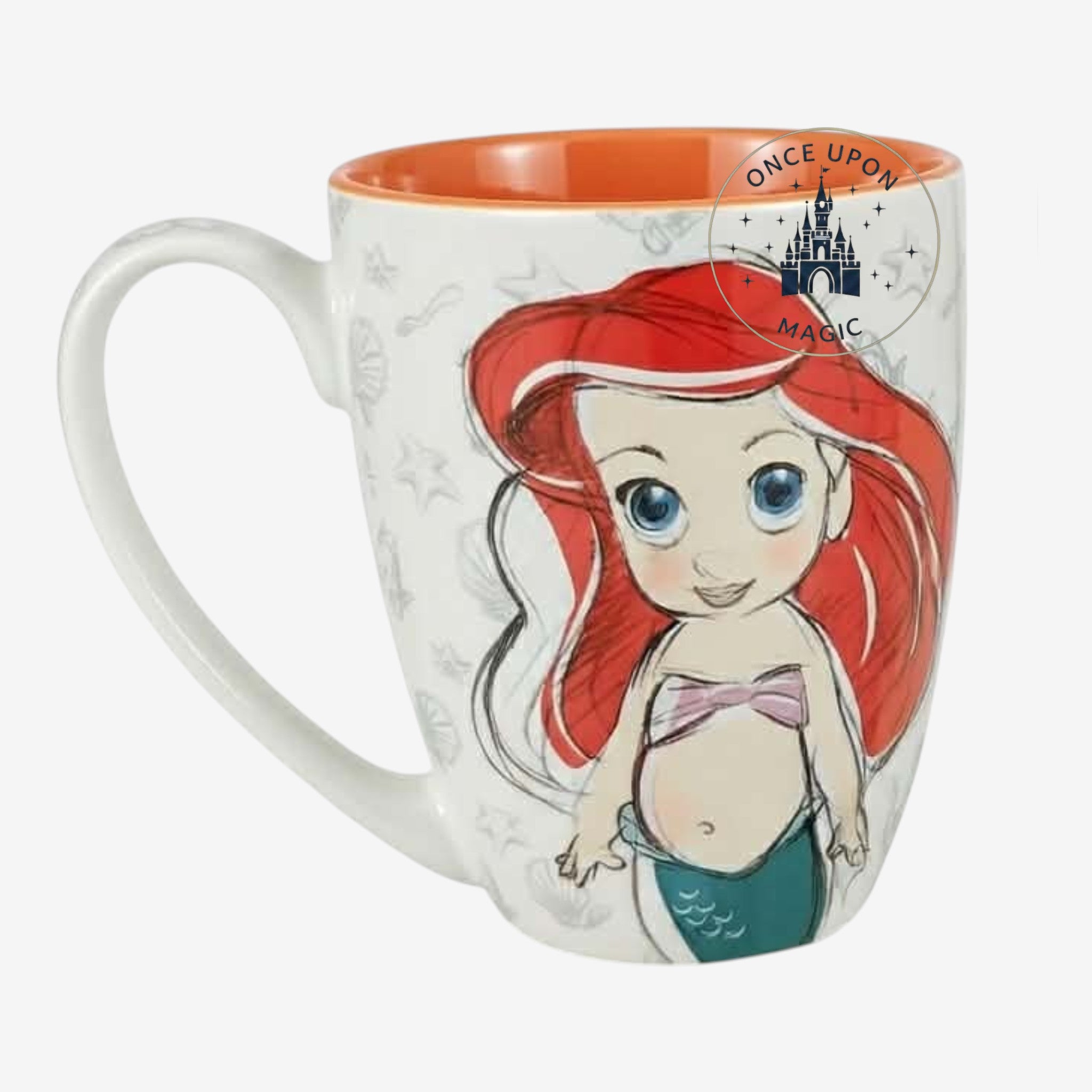 Once Upon Magic white ceramic mug featuring a chibi Ariel from The Little Mermaid with red hair, blue eyes, and a teal tail. Subtle seashell patterns adorn the mug.