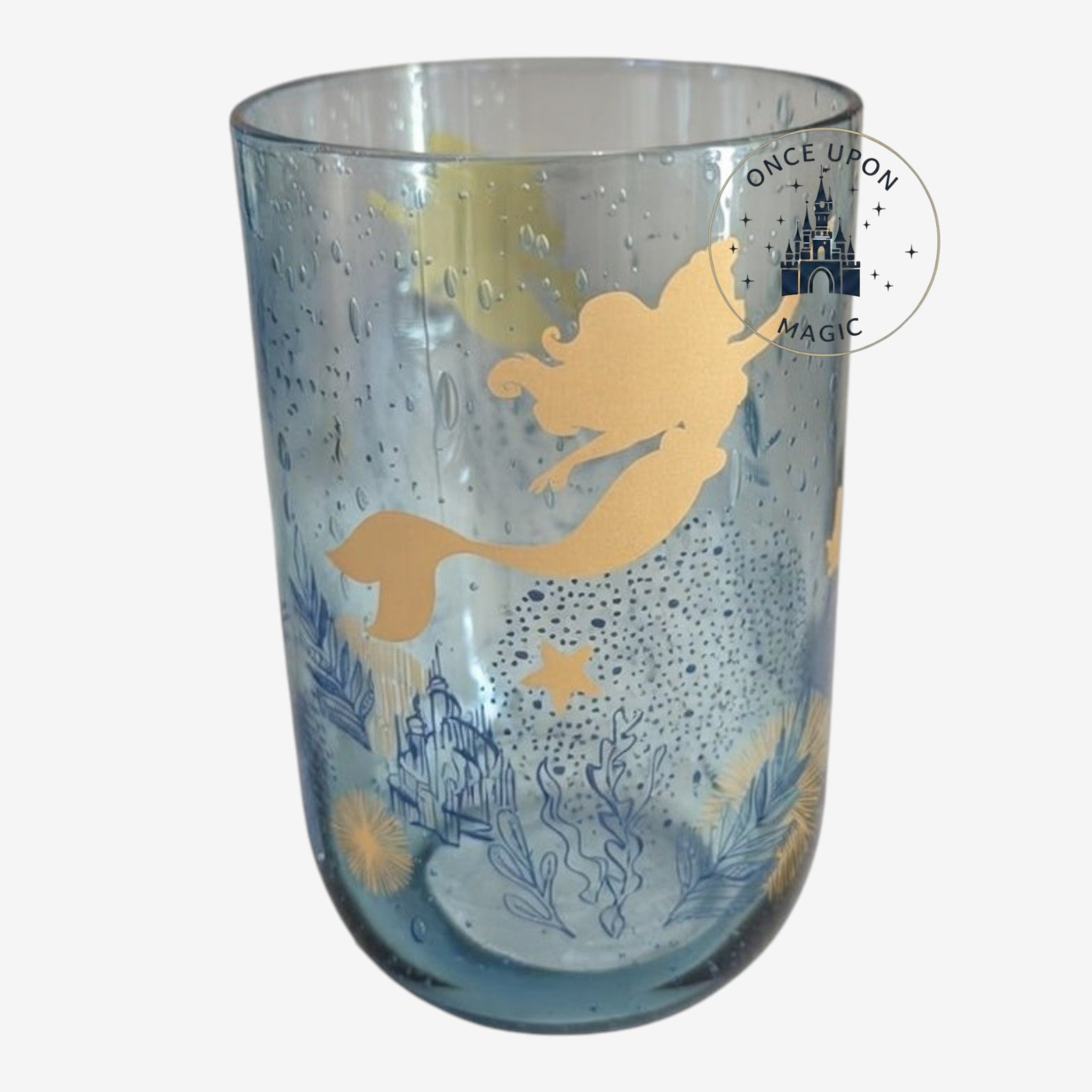 Once Upon Magic Disney Ariel glass in translucent blue with gold mermaid silhouette and underwater bubble motifs.