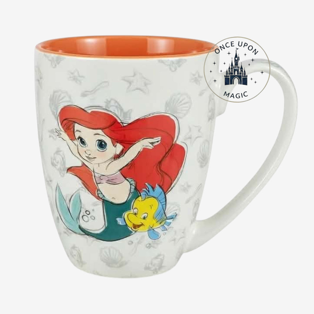 Once Upon Magic The Little Mermaid Ariel and Flounder mug with orange interior and sea shell pattern.