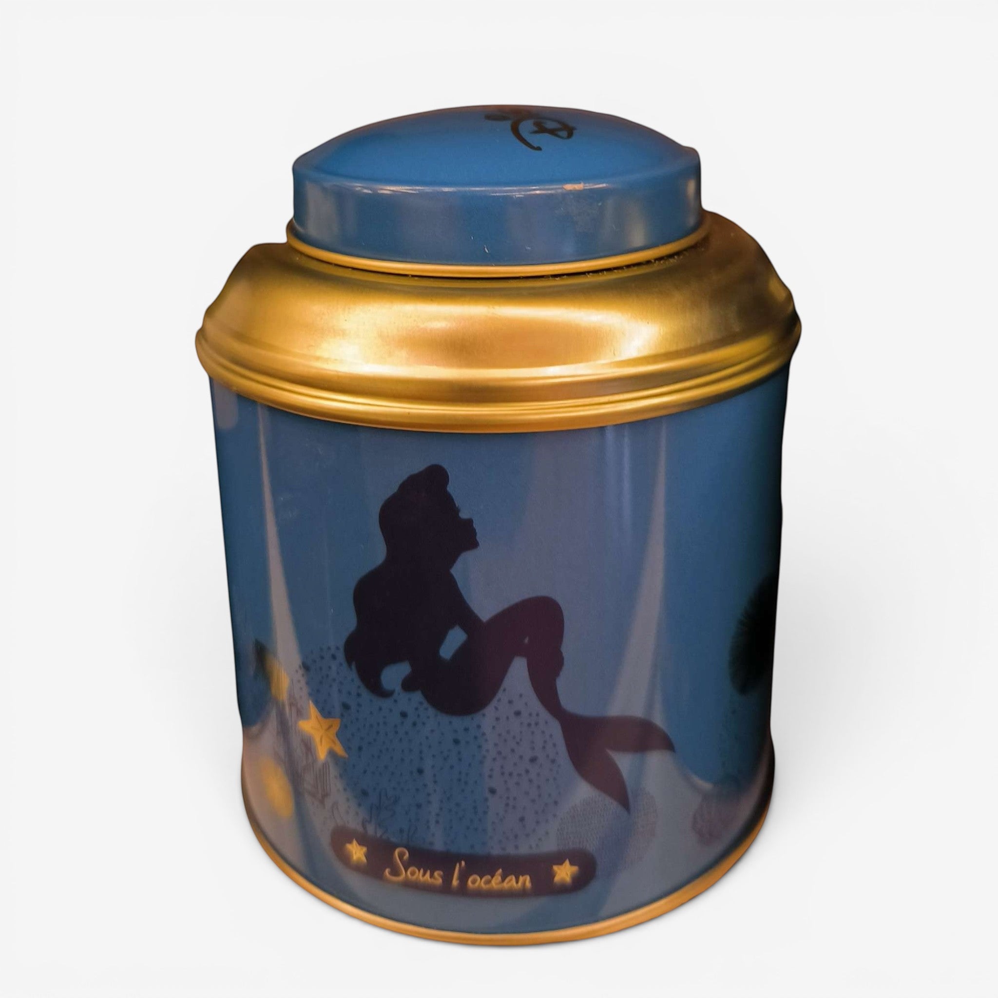 Once Upon Magic Ariel The Little Mermaid tea tin featuring a blue design with gold accents and a silhouette of Ariel.