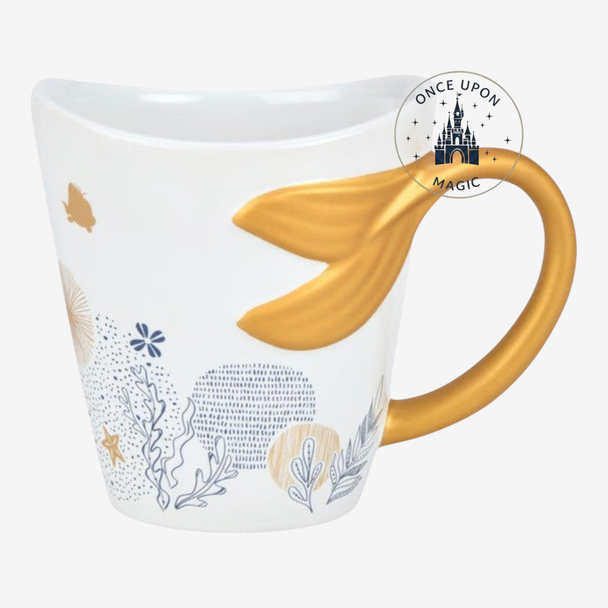 Once Upon Magic white ceramic mug with gold mermaid tail handle, featuring Ariel silhouette and aquatic motifs.