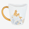 Once Upon Magic white ceramic mug with gold Ariel silhouette, coral reef design, and gold mermaid tail handle.
