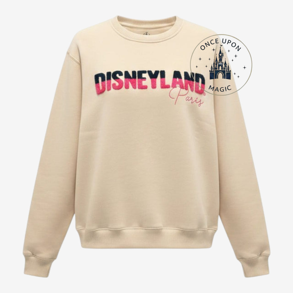 Once Upon Magic beige Disneyland Paris crewneck sweatshirt with textured pink and black lettering