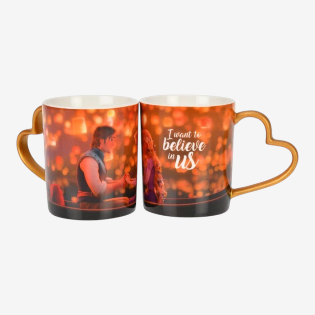 Once Upon Magic ceramic mug with heart-shaped handle, featuring a romantic scene and "I want to believe in us" quote.