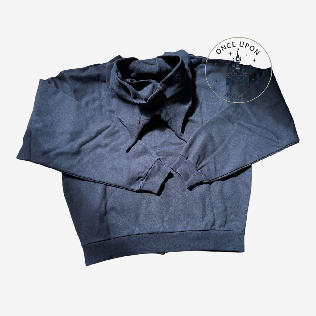 Once Upon Magic black Coperni Maléfique sweatshirt with a unique folded collar design laid flat on a wooden floor.