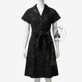 Once Upon Magic black Disney dress with gold castle print, button-down front, and tie waist on a mannequin