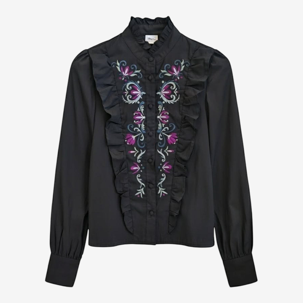 Once Upon Magic black long-sleeve blouse with embroidered floral details in purple, pink, and blue, featuring ruffled front and high neck.