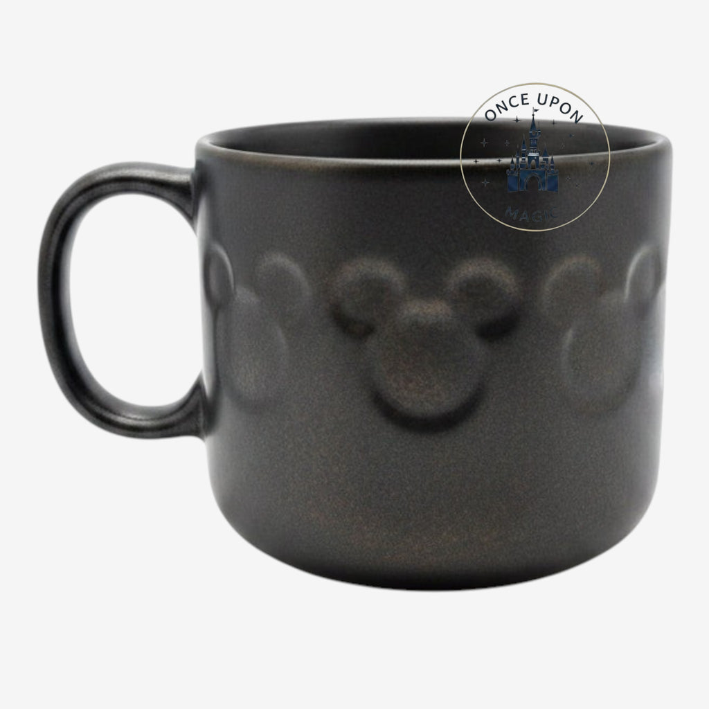 Once Upon Magic black ceramic mug featuring embossed Mickey Mouse icons from the Disneyland Paris Home collection.