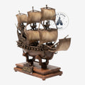 Once Upon Magic Black Pearl ship figurine with aged bronze finish on a wooden base, Pirates of the Caribbean theme.