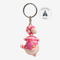 Once Upon Magic Cheshire Cat keychain, pink and white striped rubber charm with a wide grin.