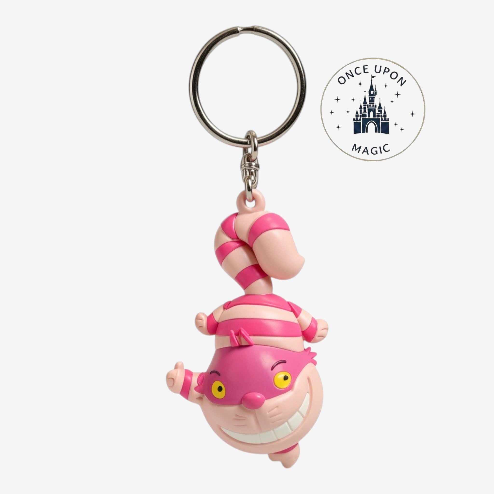 Once Upon Magic Cheshire Cat keychain, pink and white striped rubber charm with a wide grin.