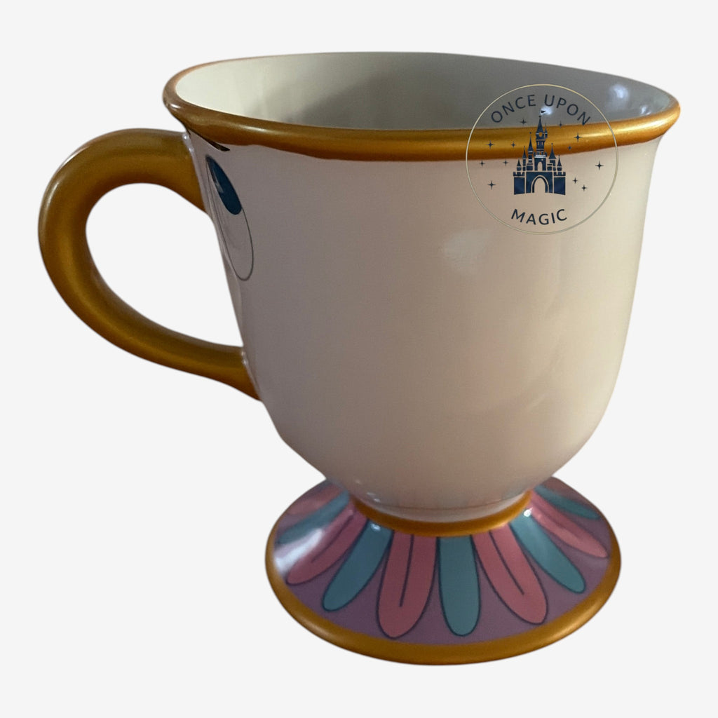 Once Upon Magic Chip mug from Beauty and the Beast with gold handle, rim, and floral base.