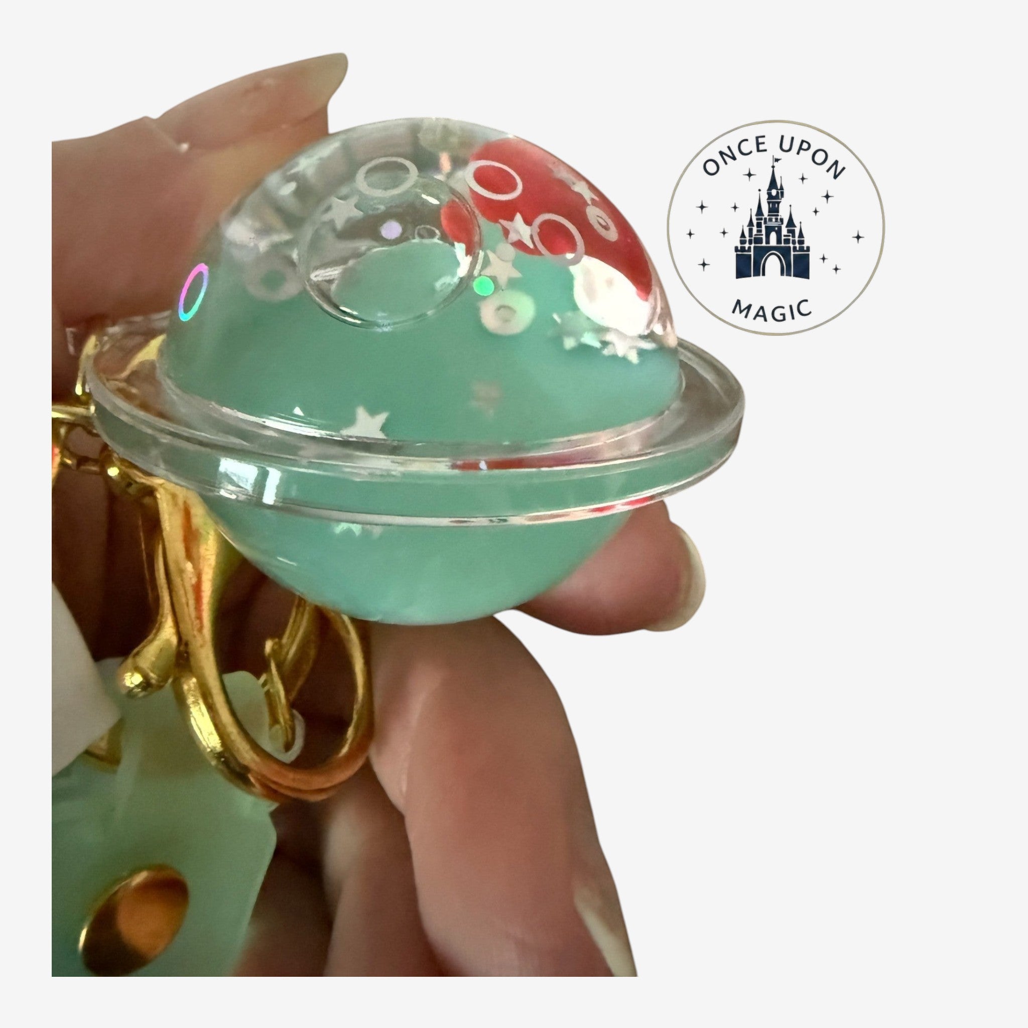 Once Upon Magic Disney Ariel planet keychain with seafoam green liquid, stars, and Ariel figure. Gold hardware.