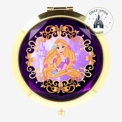 Once Upon Magic gold compact mirror with Rapunzel illustration on purple background, ornate gold trim.