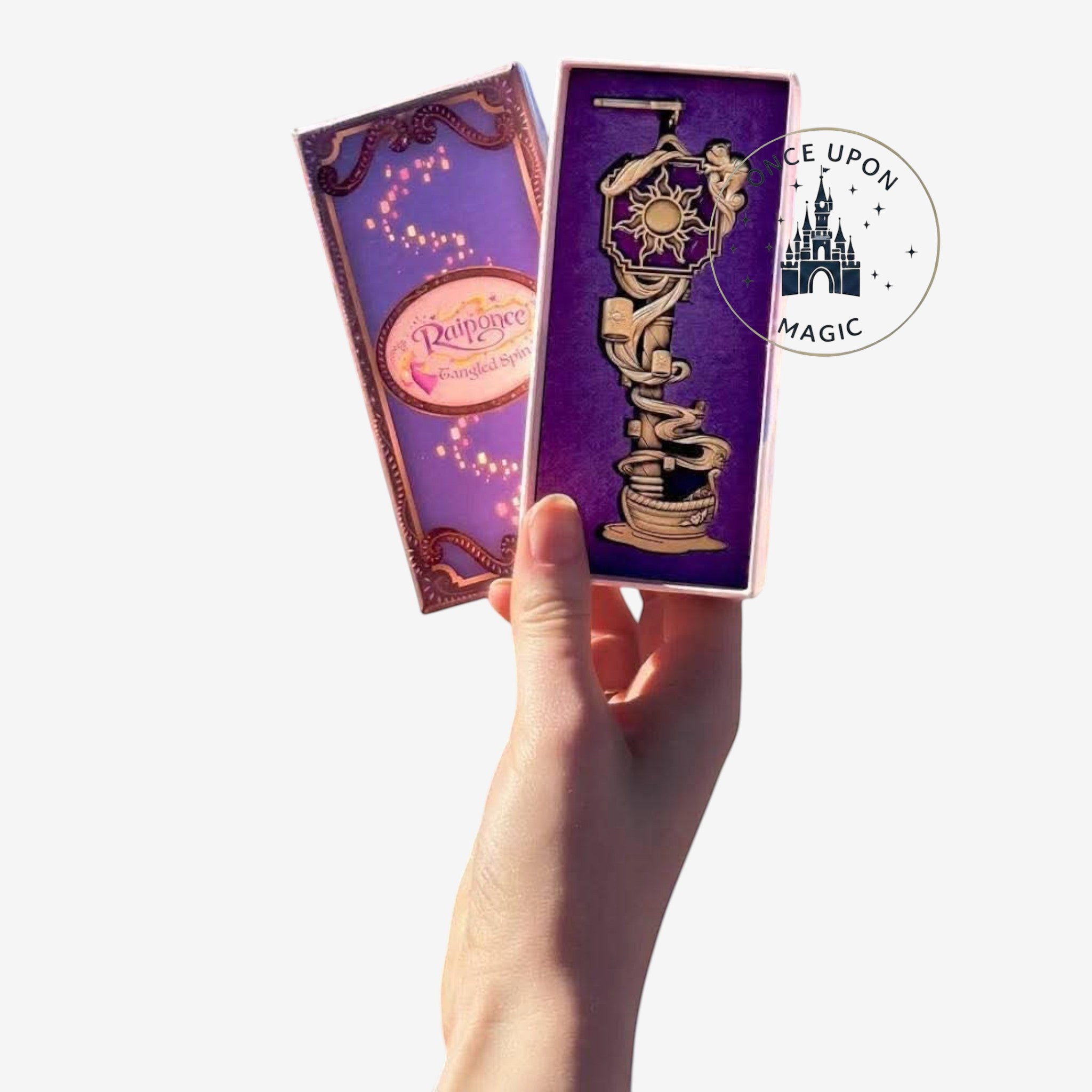 Once Upon Magic Disneyland Paris exclusive Rapunzel key collector item, gold metal with sculpted tower and lantern details.