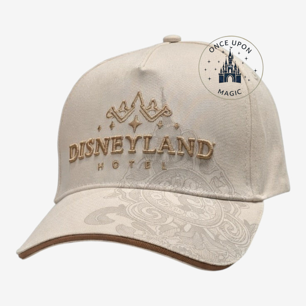 Once Upon Magic cream baseball cap with gold Disneyland Hotel embroidery and intricate tonal brim patterns.
