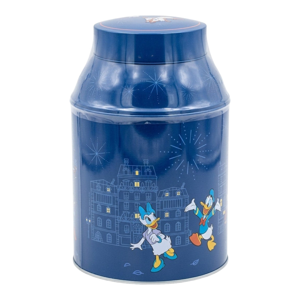 Once Upon Magic Disneyland Paris character tin with Mickey, Minnie, Donald, Daisy, Pluto, Chip 'n' Dale on a deep blue background with cityscape and fireworks.