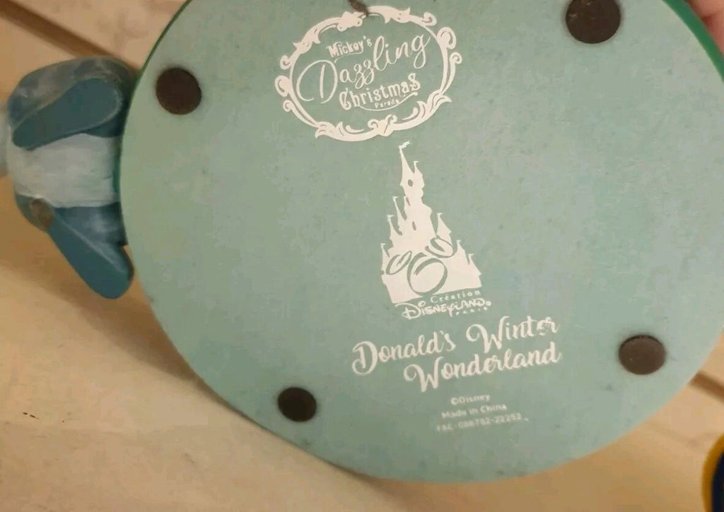 Once Upon Magic Disneyland Paris Donald's Winter Wonderland figurine base with official branding and logo