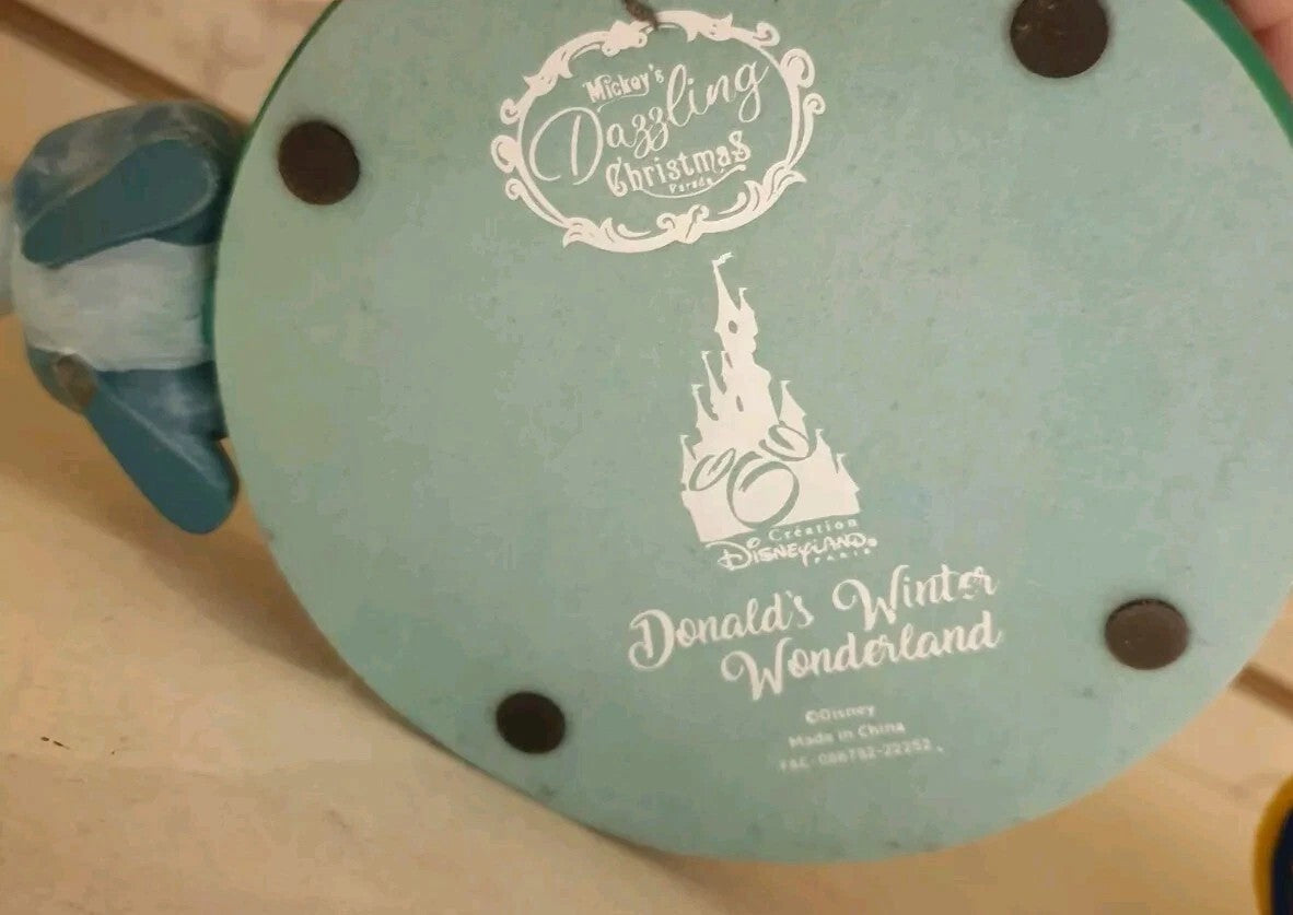 Once Upon Magic Disneyland Paris Donald's Winter Wonderland figurine base with official branding and logo