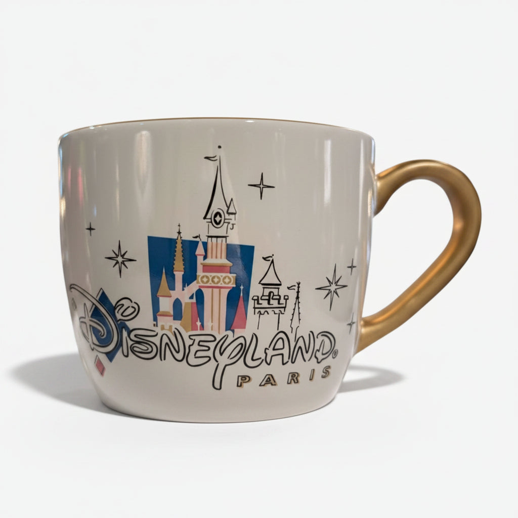 Once Upon Magic Disneyland Paris 2024 ceramic mug with castle graphic and gold handle.