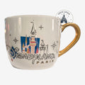 Once Upon Magic Disneyland Paris 2024 ceramic mug with castle graphic and gold handle.