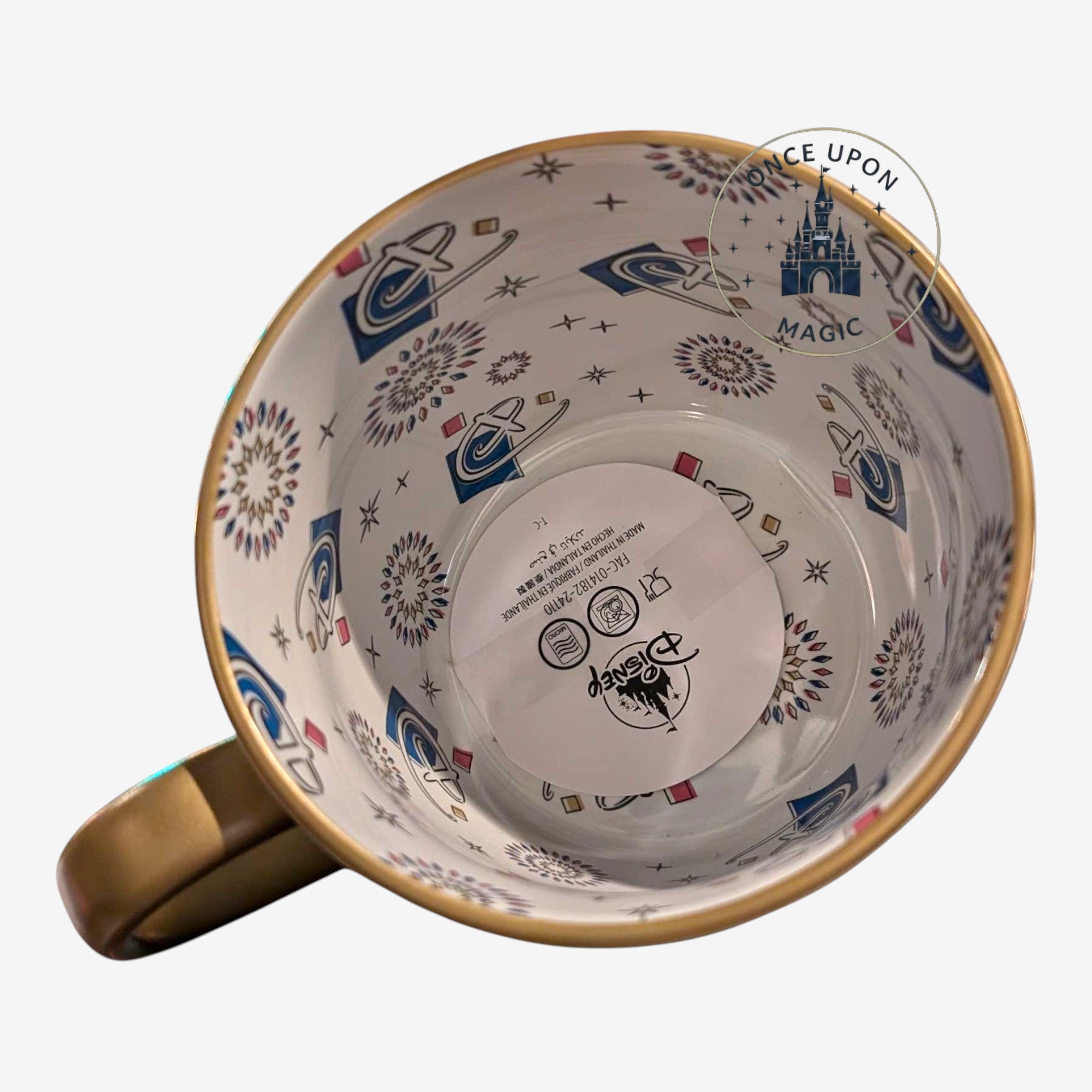 Once Upon Magic Disneyland Paris 2024 ceramic mug with gold handle and inner pattern.