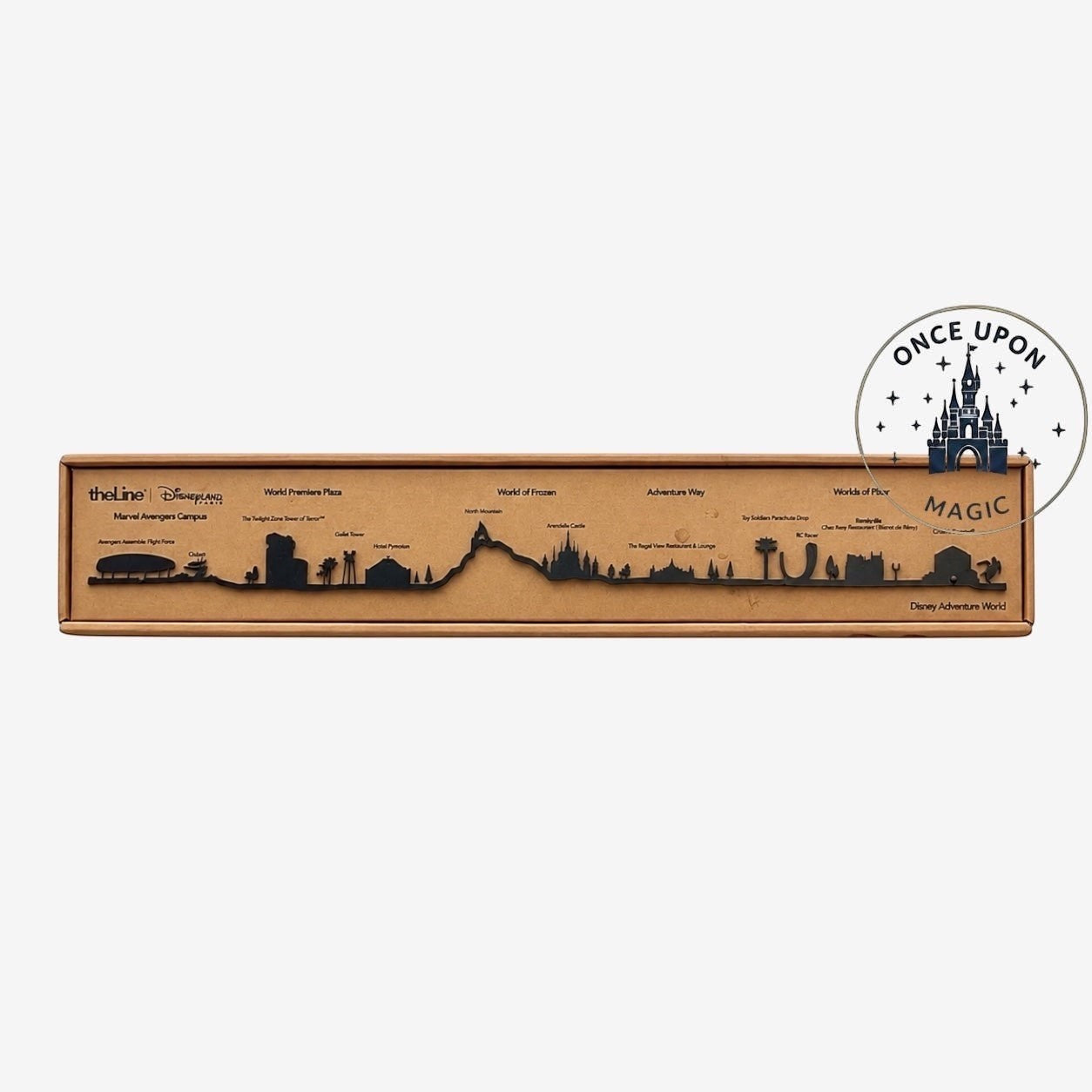 Once Upon Magic Disneyland Paris Adventure World skyline decoration. Black silhouette art on brown cardboard.