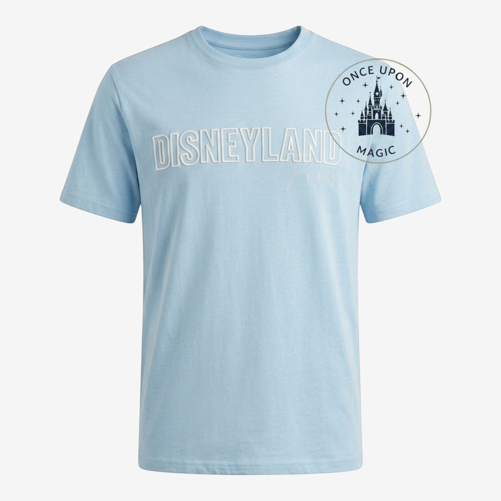 Once Upon Magic light blue cotton t-shirt with embroidered Disneyland Paris text and castle graphic.