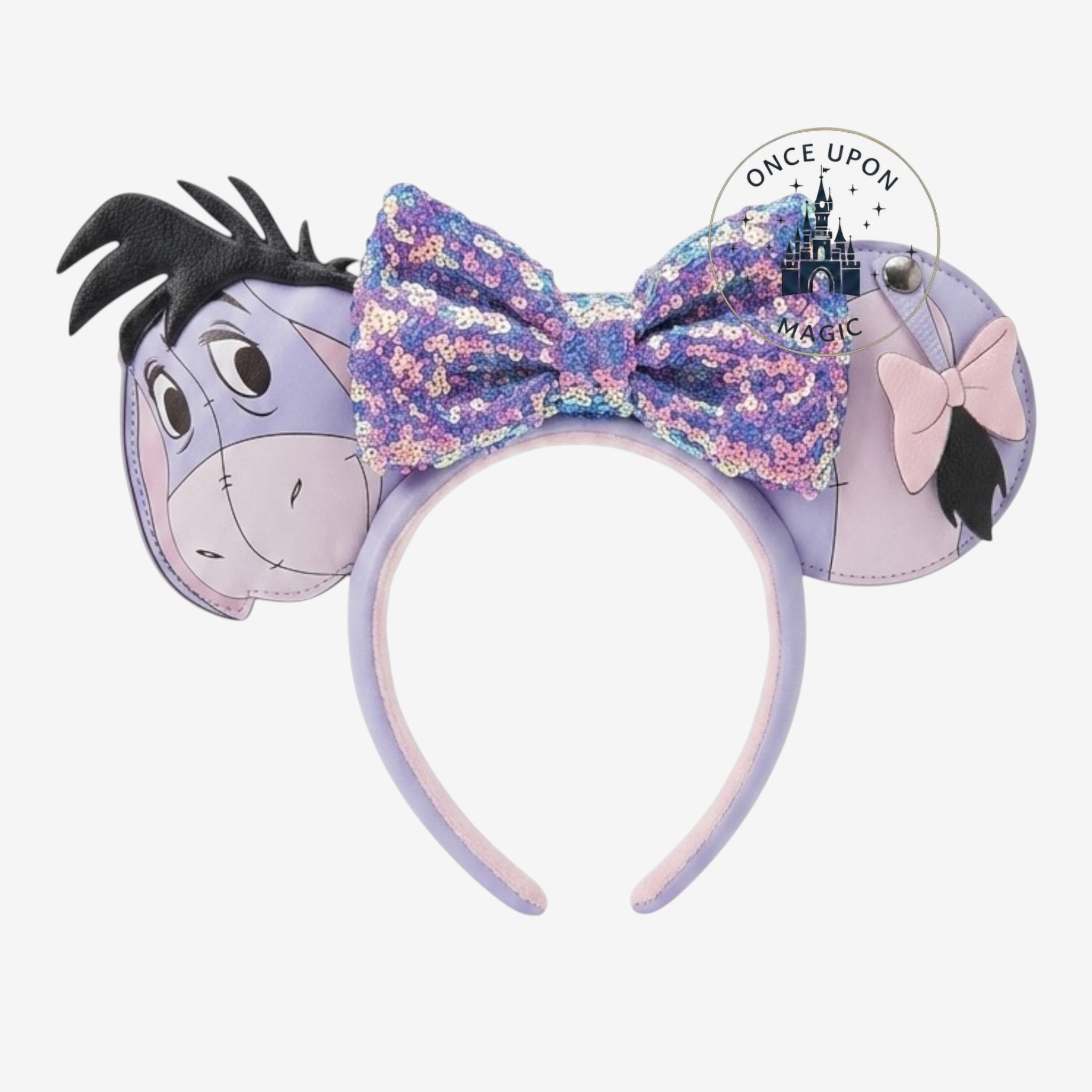 Once Upon Magic Eeyore ears headband with purple sequin bow and pink bow detail. Soft purple and grey.