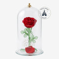 Once Upon Magic Enchanted Rose Dome: a preserved deep red rose with glass stem and leaves under a glass dome, featuring a gold finial and etched Beauty and the Beast logo.