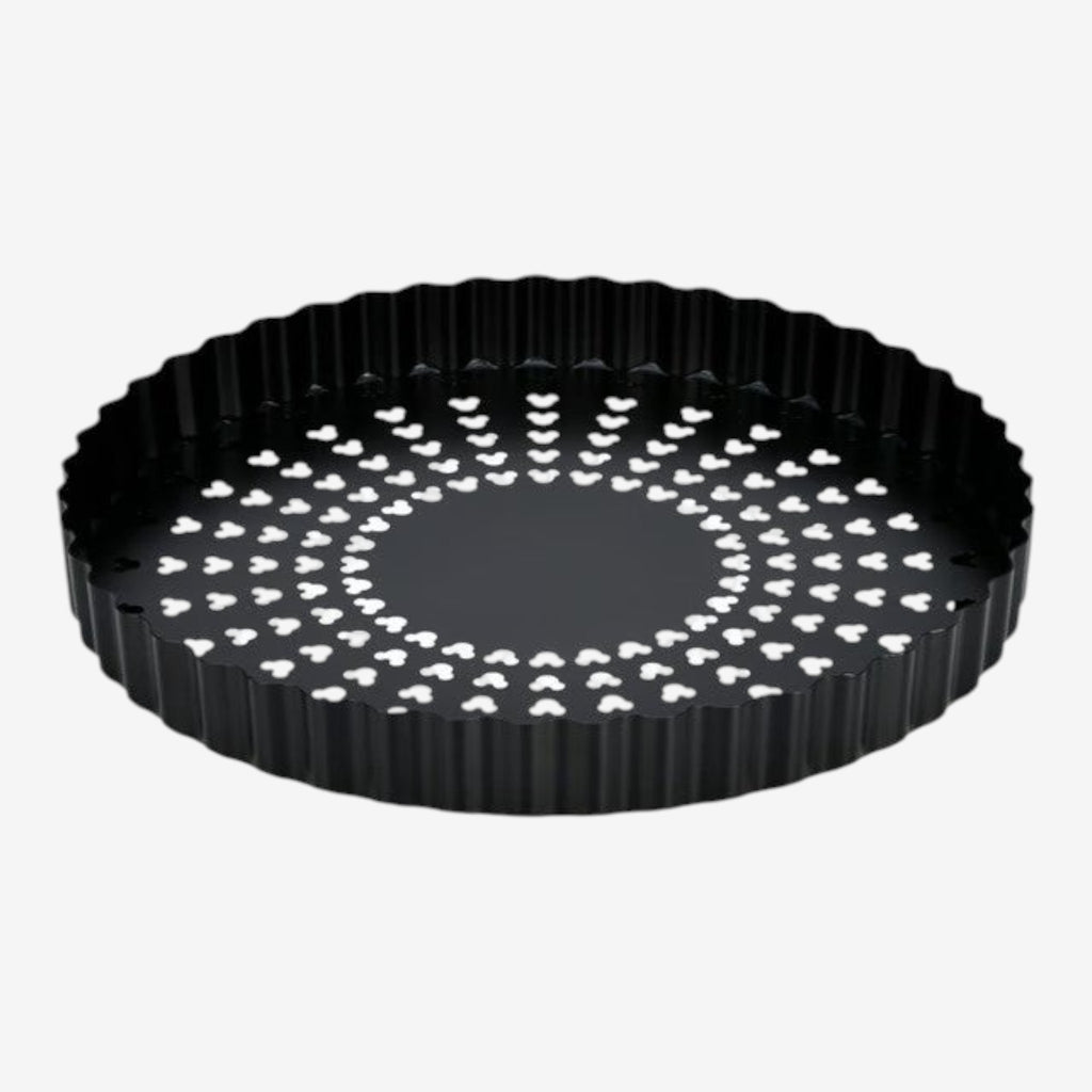 Once Upon Magic black fluted tart pan with removable bottom and perforated surface for even baking.