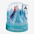 Once Upon Magic Frozen snow globe featuring Elsa and Anna in front of the ice castle with a blue Disneyland Paris base