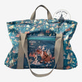 Once Upon Magic World of Frozen tote bag with Olaf, Sven, and Arendelle castle print. Teal blue with grey straps.