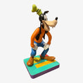 Once Upon Magic Goofy figurine from Disneyland Paris, wearing orange shirt, blue pants, and green hat. Made of resin/PVC.