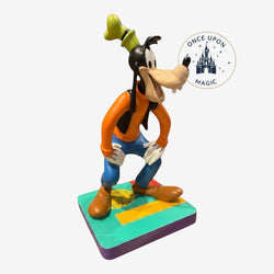 Once Upon Magic Goofy figurine from Disneyland Paris, wearing orange shirt, blue pants, and green hat. Made of resin/PVC.