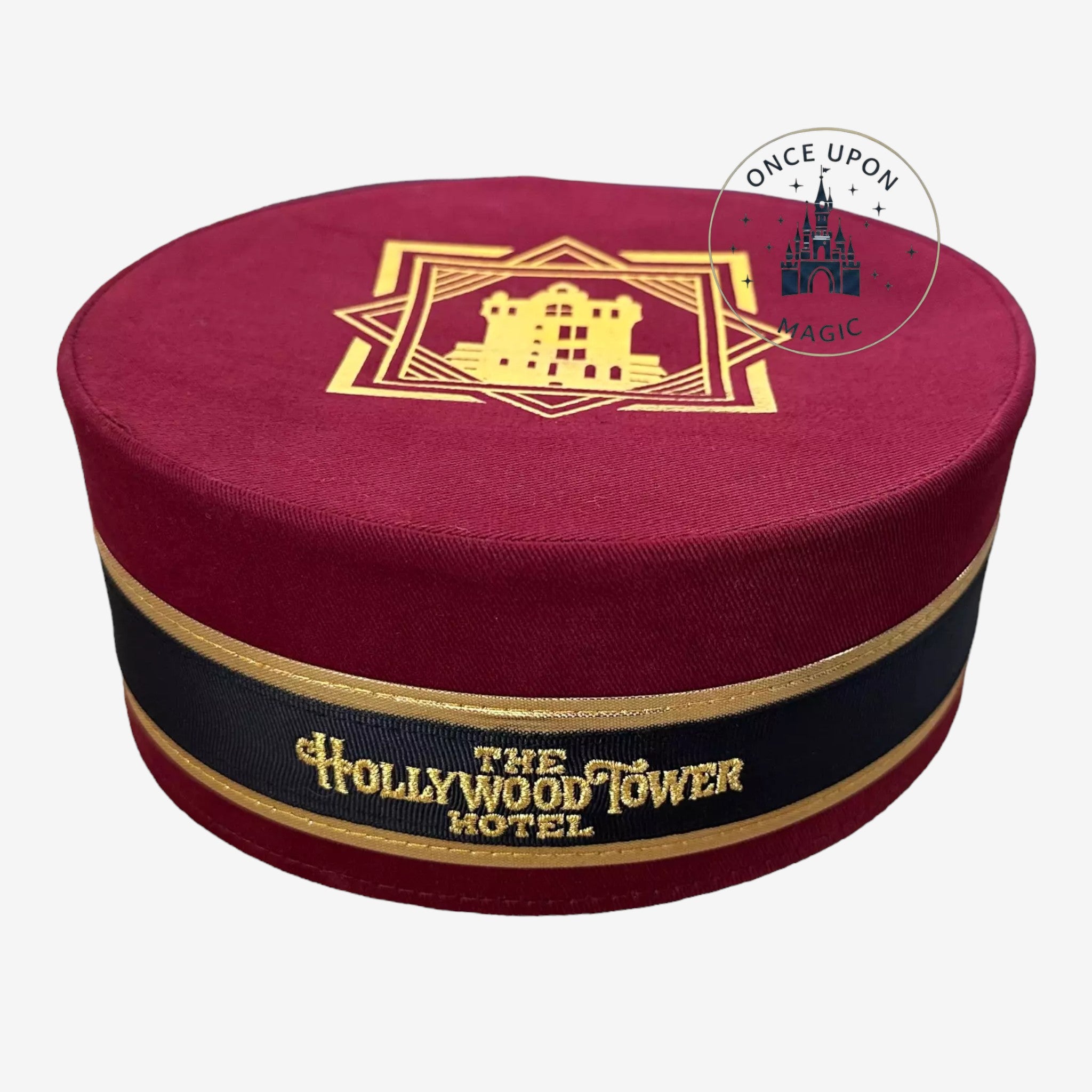 Once Upon Magic burgundy pillbox hat featuring The Hollywood Tower Hotel gold embroidery and black ribbon trim