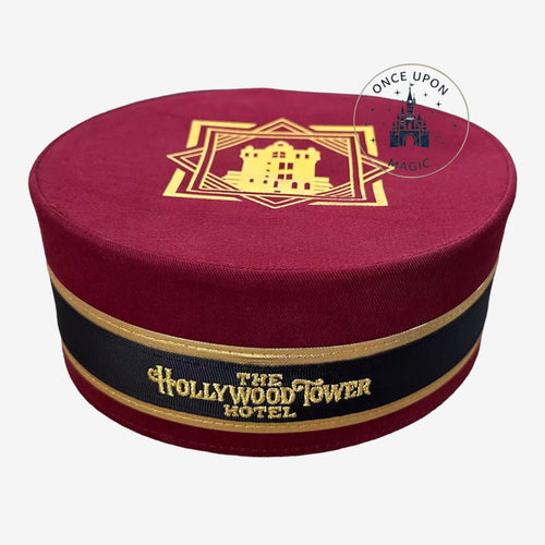Once Upon Magic burgundy pillbox hat featuring The Hollywood Tower Hotel gold embroidery and black ribbon trim