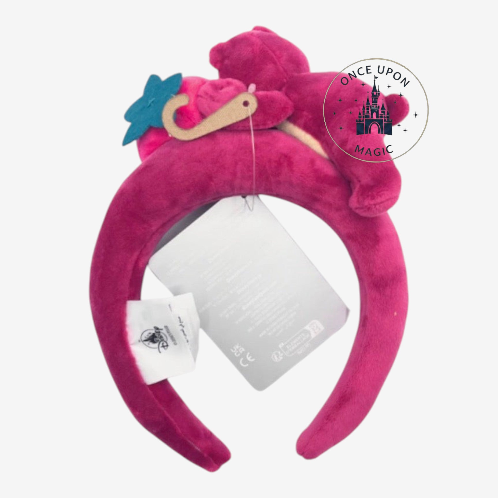 Once Upon Magic Disney Lotso plush character headband in vibrant magenta velvet with strawberry and flower details.