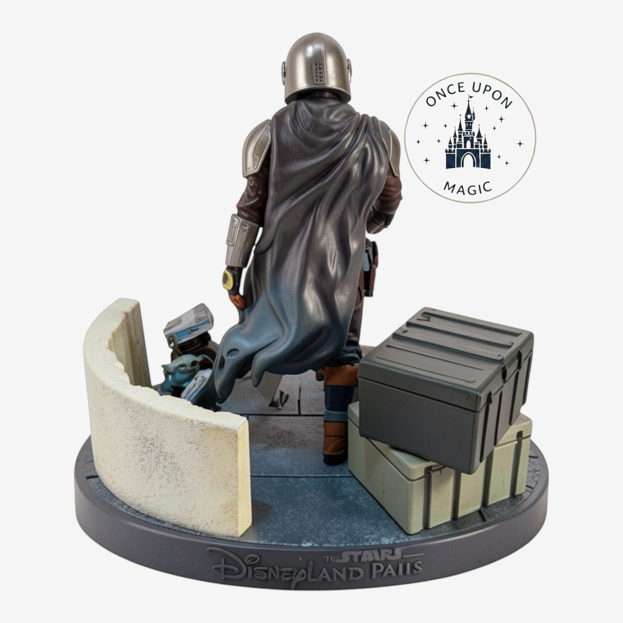 Once Upon Magic Mandalorian and Grogu figurine with detailed armor, cape, and accessories on a themed base.