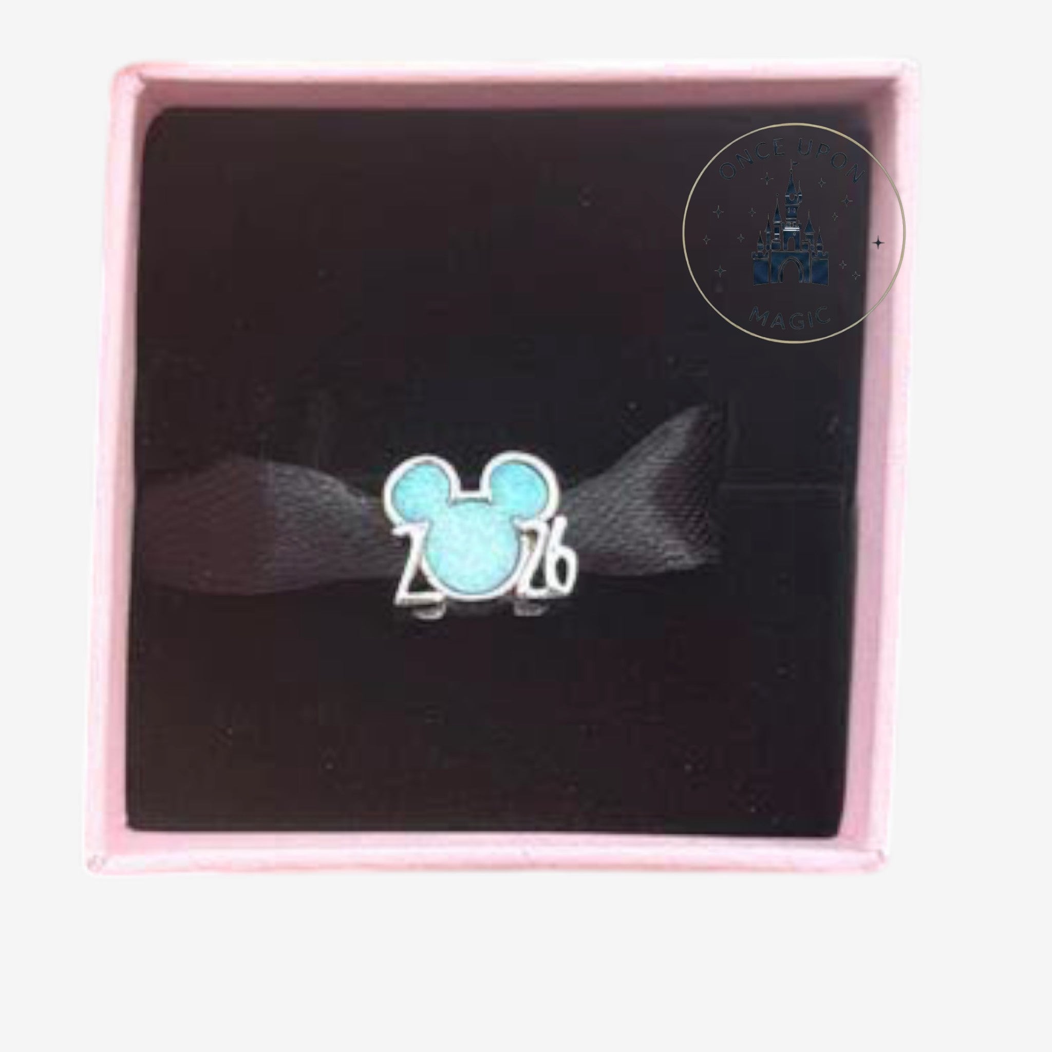 Once Upon Magic Mickey Mouse 2026 commemorative charm with shimmering blue enamel in a pink gift box.