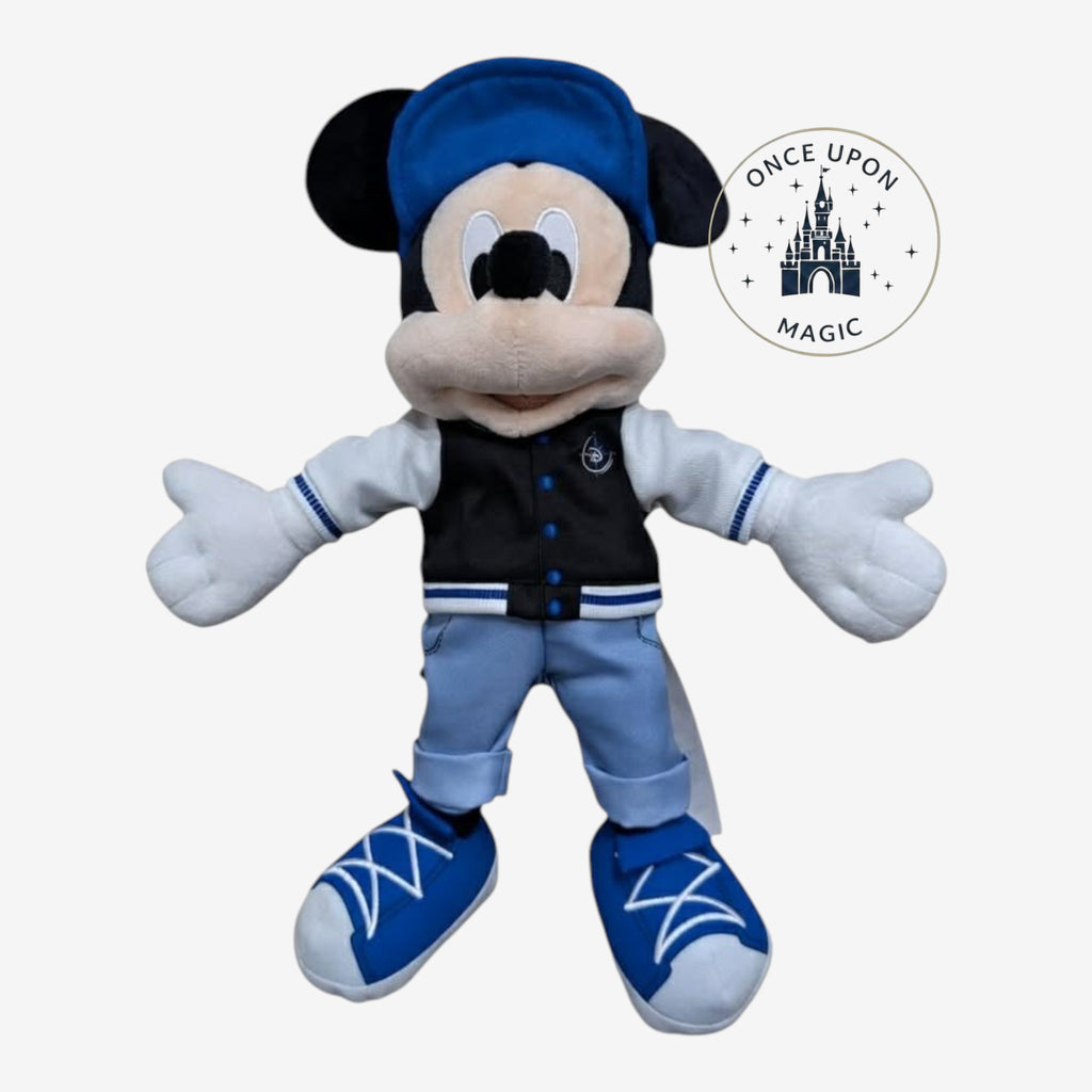 Once Upon Magic Mickey Mouse plush in Adventure World outfit with blue cap, varsity jacket, and sneakers.