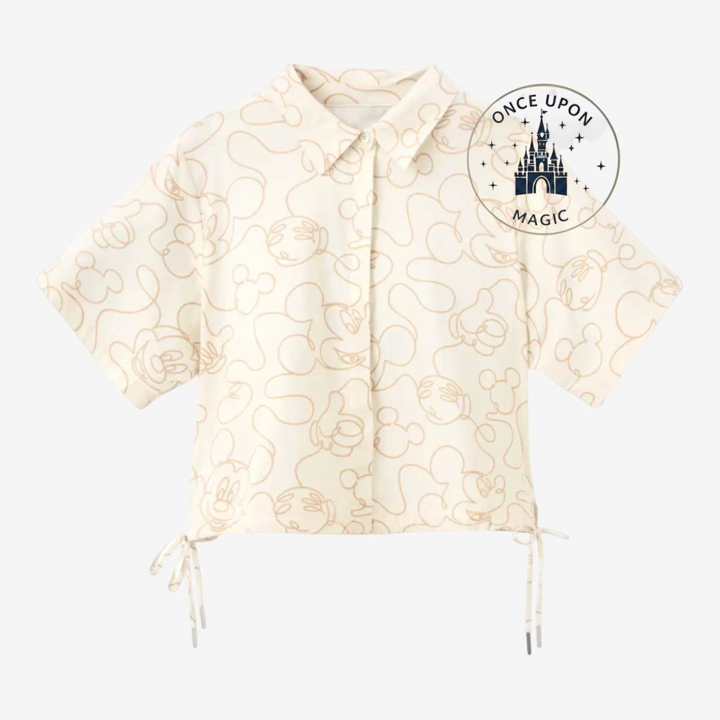 Once Upon Magic cream short-sleeve button-up shirt with all-over beige Mickey Mouse line art and drawstring sides.