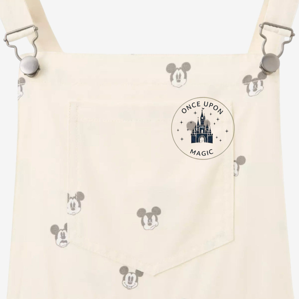 Once Upon Magic cream cotton blend overall shorts with all-over Mickey Mouse print and front pocket.