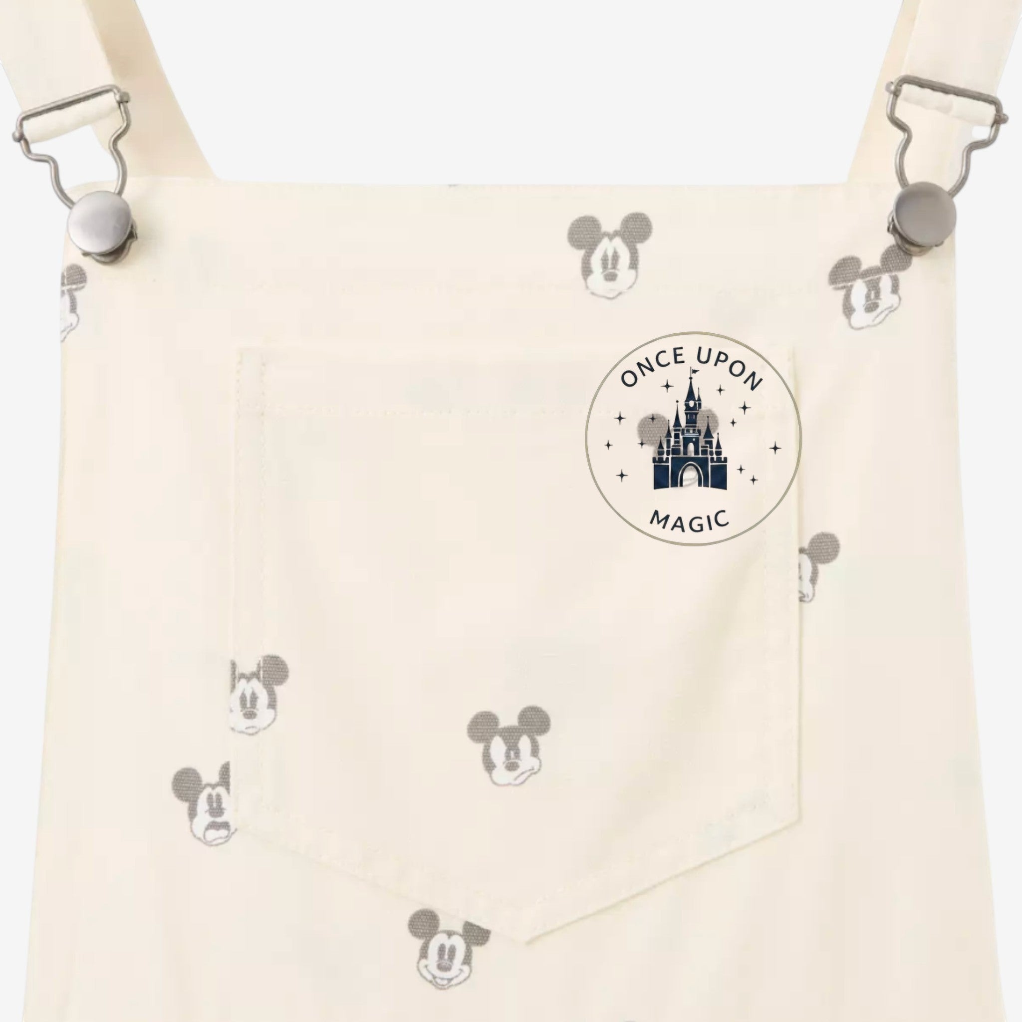 Once Upon Magic cream cotton blend overall shorts with all-over Mickey Mouse print and front pocket.