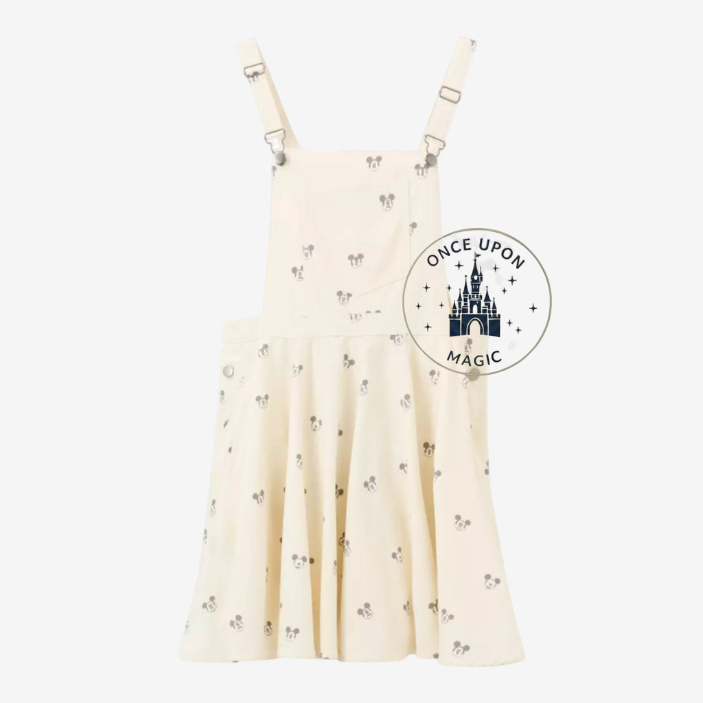 Once Upon Magic cream cotton blend overall shorts with all-over Mickey Mouse print, adjustable straps, and button sides.