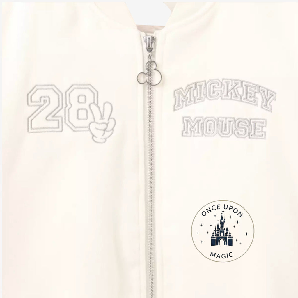 Once Upon Magic cream teddy varsity jacket with Mickey Mouse embroidery and "28" graphic.