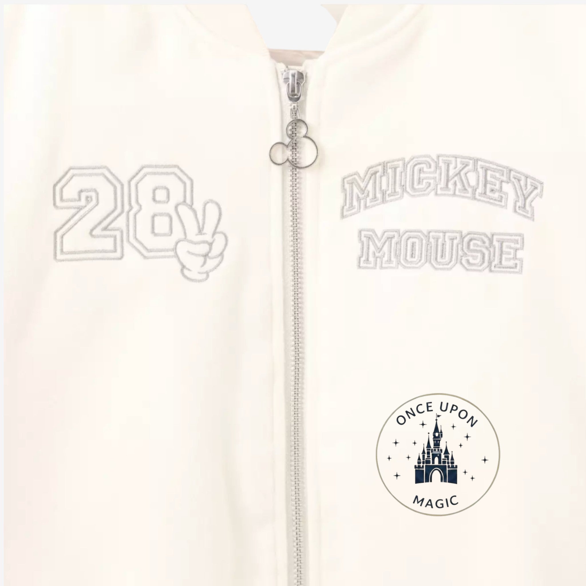 Once Upon Magic cream teddy varsity jacket with Mickey Mouse embroidery and "28" graphic.